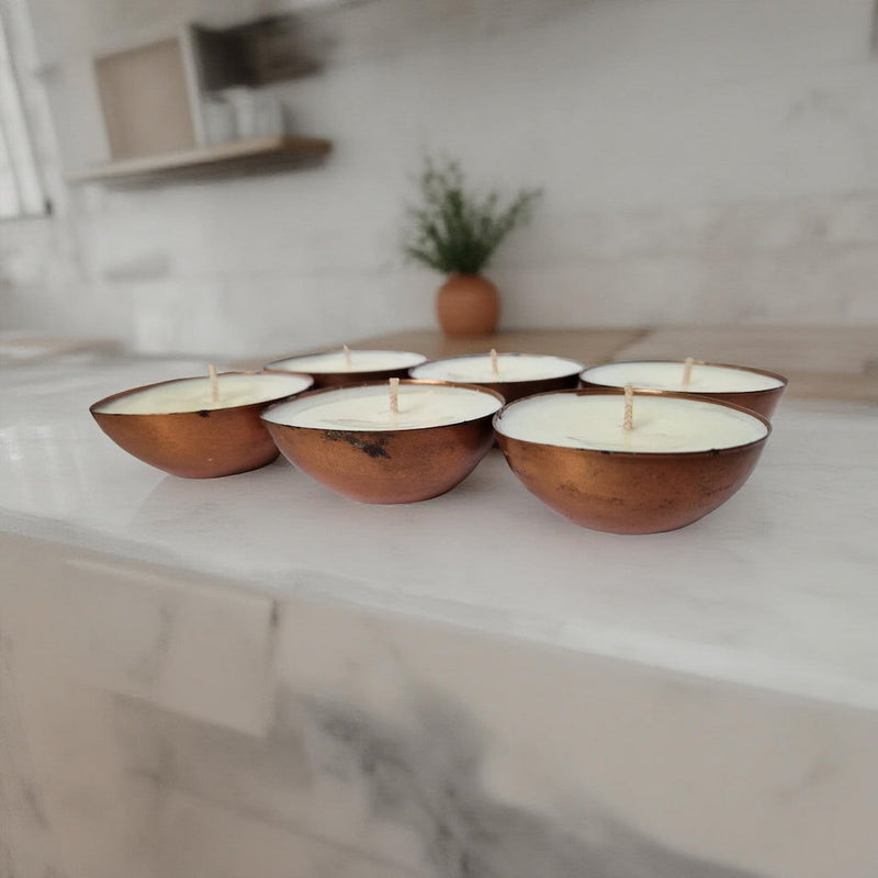 Wooden bowls with candles on a marble surface