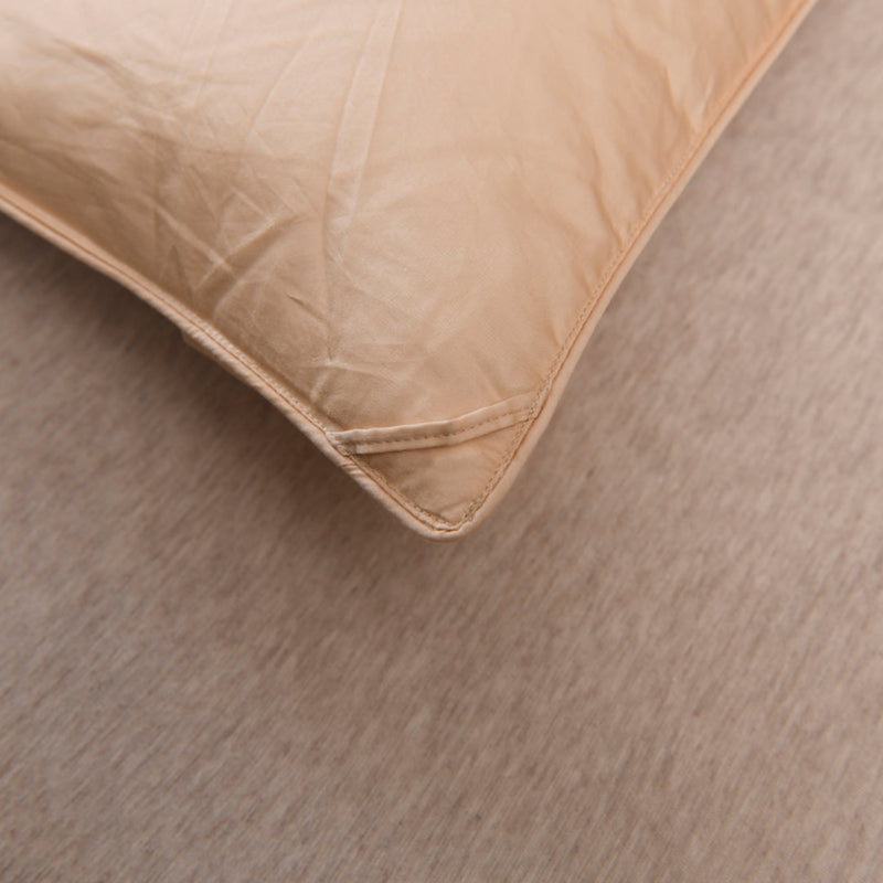 Rolled corner of beige comforter revealing layered down fill and cotton cover | LINKORI