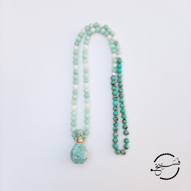 Amazonite perfume vial with amazonite and sea sediment beads. These little vials open up and come with a dropper so that you can add your favourite scent. Packaged in a luxurious pouch and a gift box.  99 beads