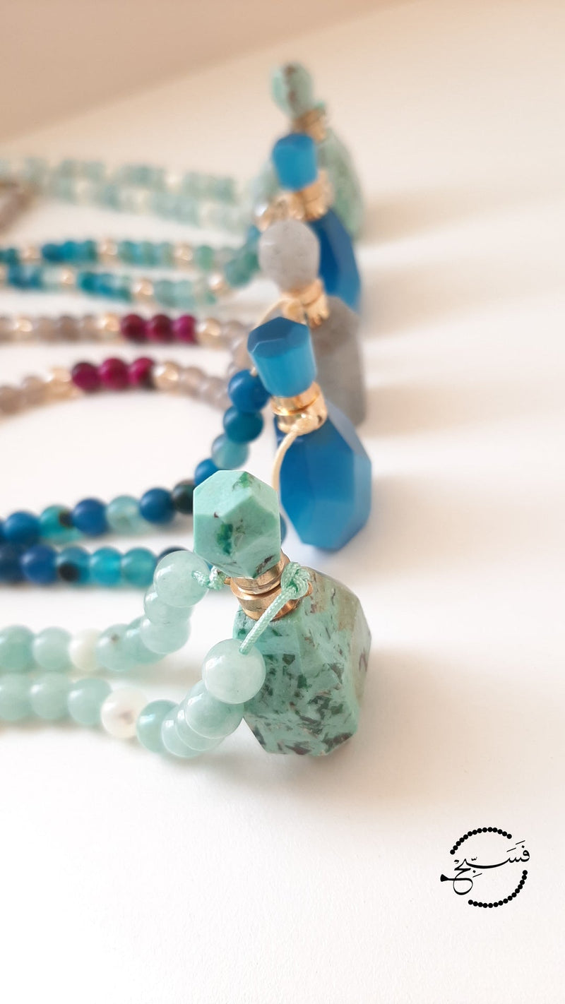 Amazonite perfume vial with amazonite and sea sediment beads. These little vials open up and come with a dropper so that you can add your favourite scent.  Packaged in a luxurious pouch and a gift box.  99 beads