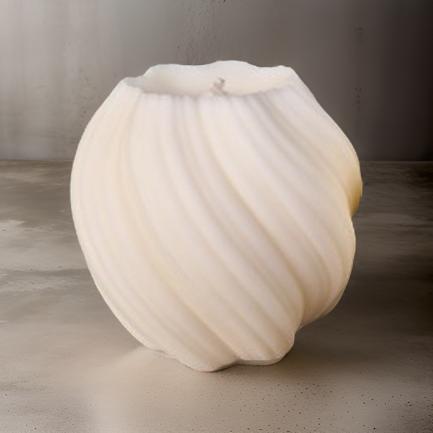 A white scented pillar candle with a twisted design, burning on a metal holder with a dark background.