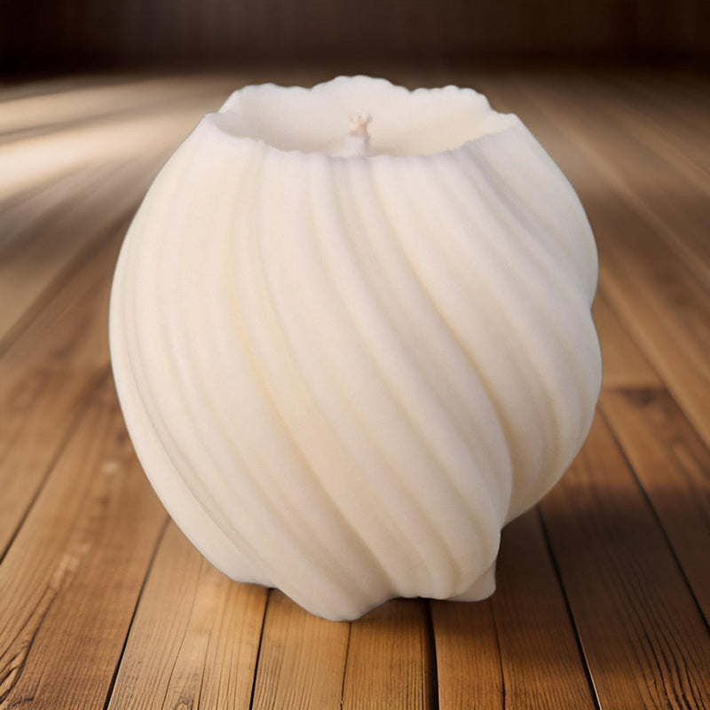 White pillar candle on a wooden surface
