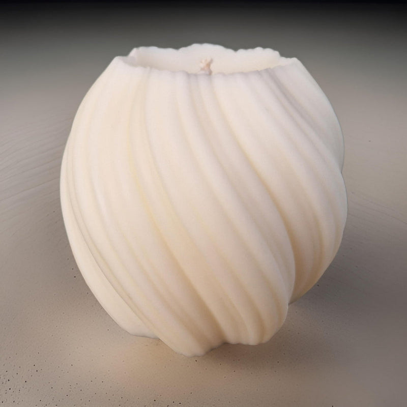 White pillar candle with ribbed texture on a neutral background