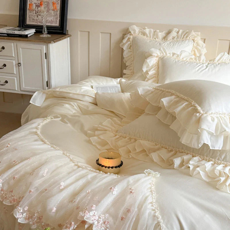 Pearl-accent lace and pillows, pearl-center floral appliqués at scallop points — LINKORI Aurace White — cottagecore bedroom