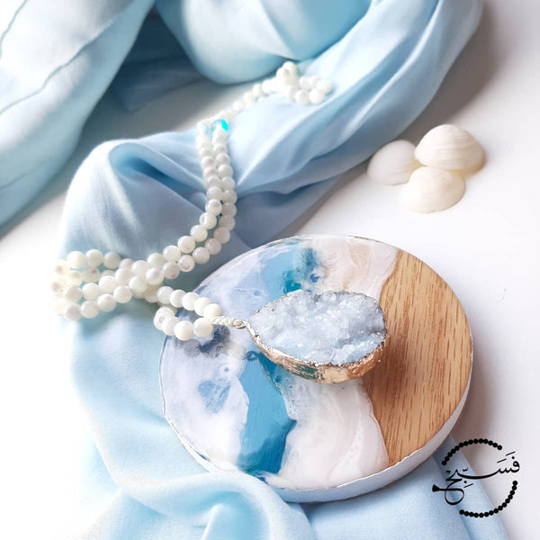 A large ice blue druzy pendant, with natural white trochus shell beads. The spacers are blue Austrian moonstone, to add just a hint of colour.  Packaged in a luxurious pouch and a gift box.  99 beads