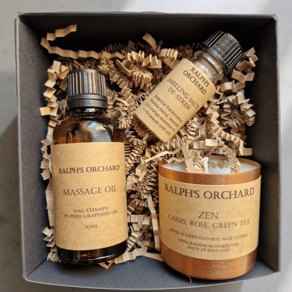 Ralph's Orchard massage oil and candle set in a box with decorative paper.