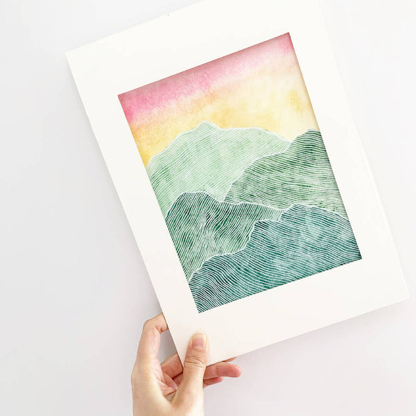 Green Yellow Pink White Ink Mountains Sky Painting Wall Decor in a White Wooden Frame