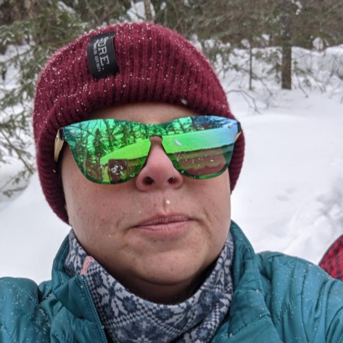Paula in the snow snowshoeing wearing the emerald sky non polarized SAARA shades